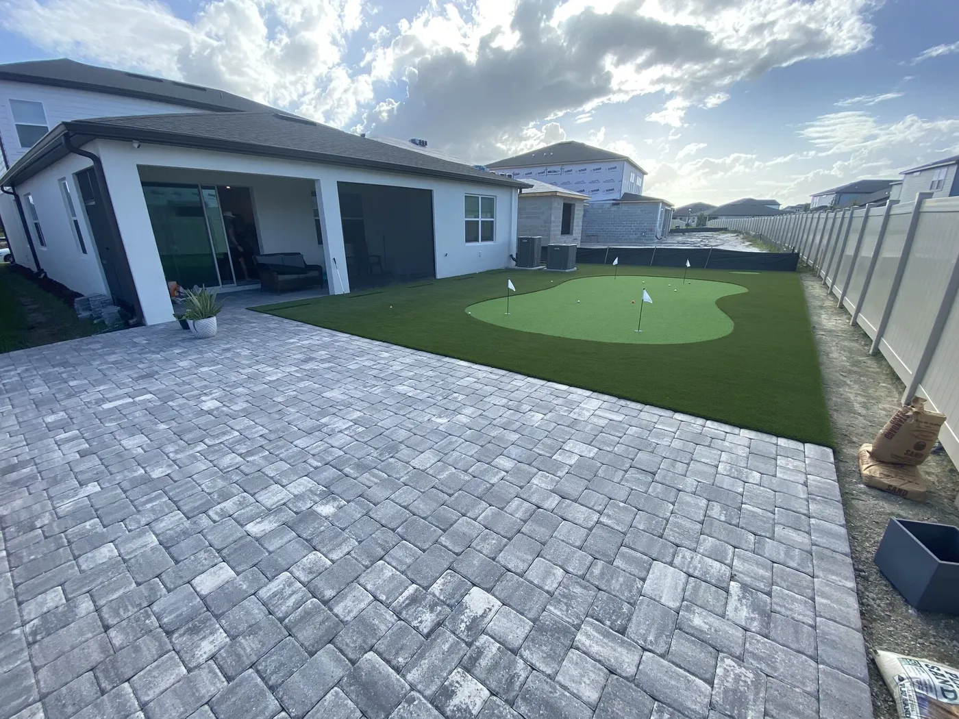 Putting green next to a paver patio
