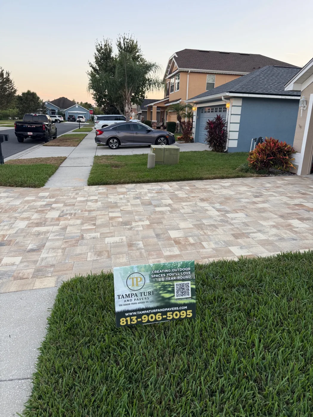 Paver driveway in front of a home with a Tampa Turf & Pavers yard sign