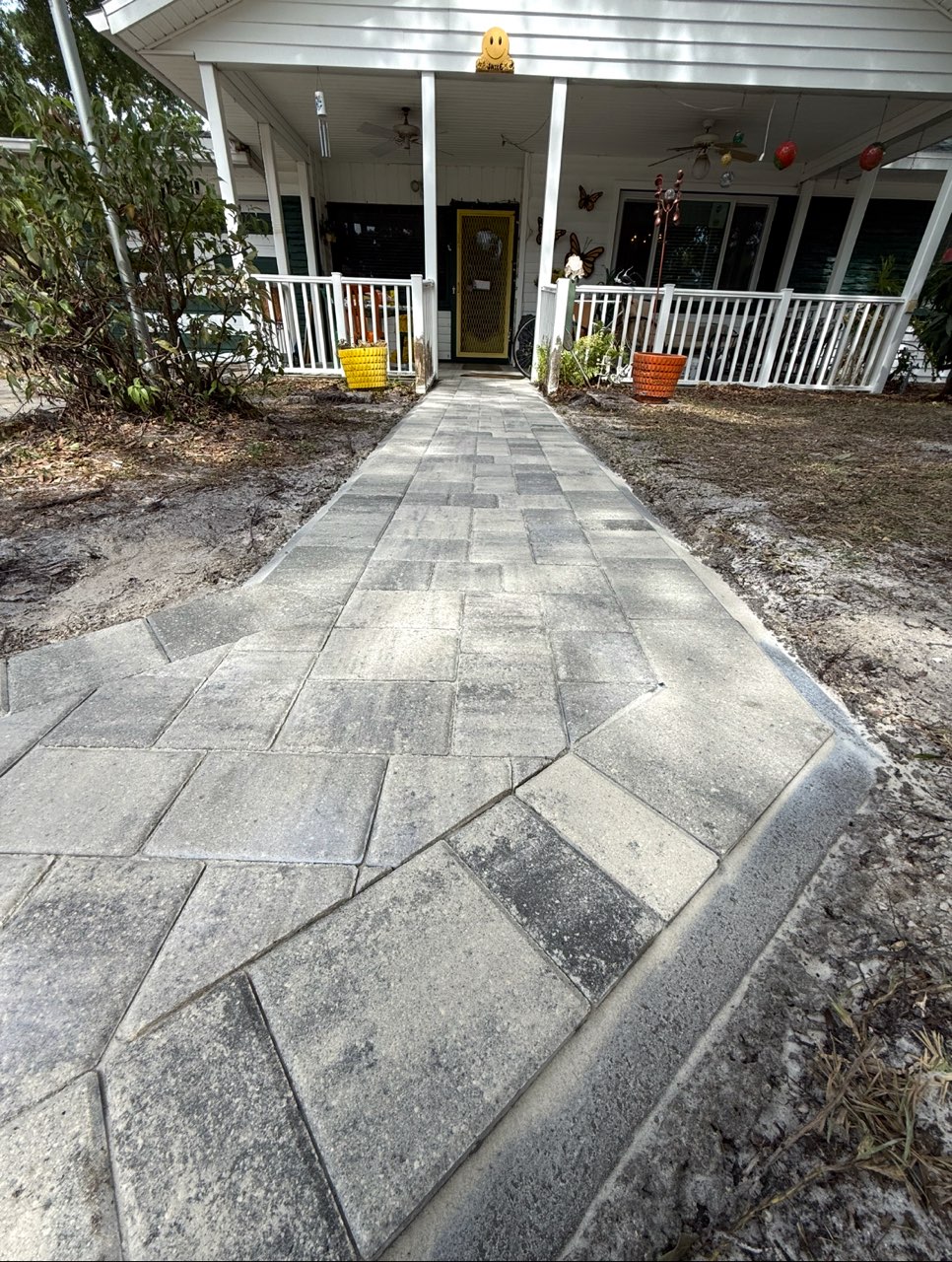 Custom paver walkway leading to a front porch in a Florida home