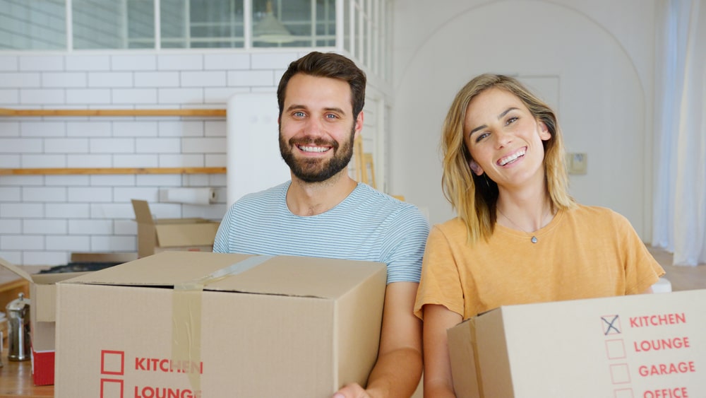 a couple moving boxes while Moving to Tampa FL